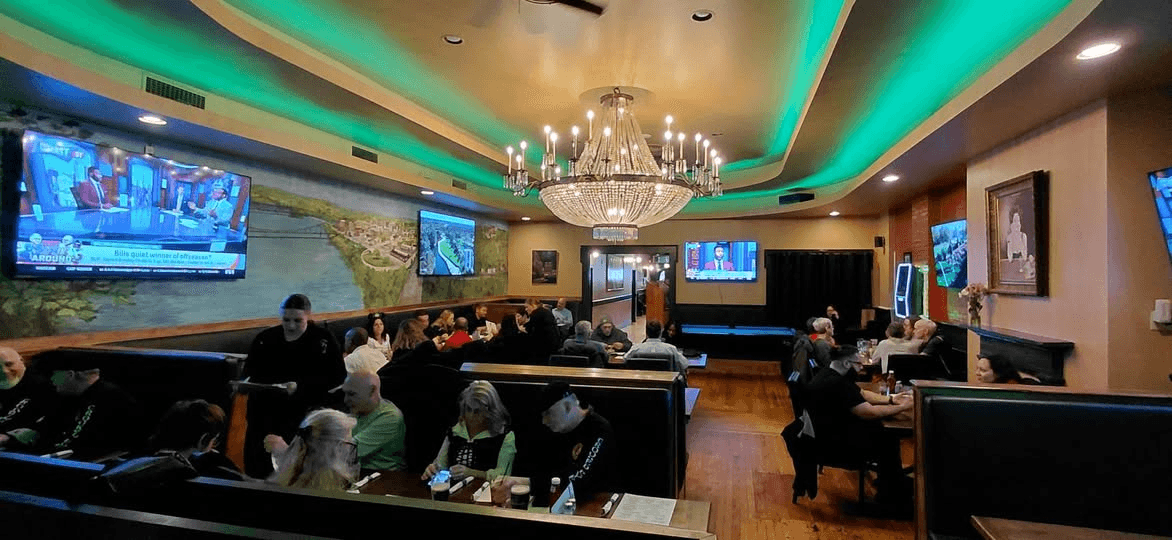 Pearly Baker's dining room with crystal chandelier and green accent lighting